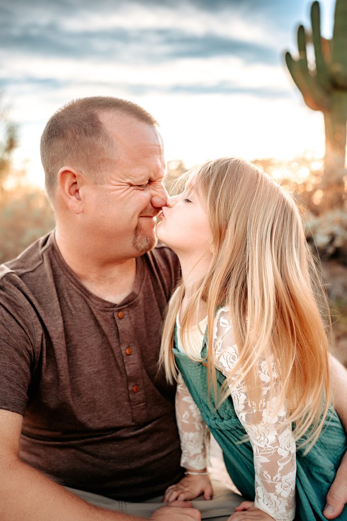 Little girl nuzzling noses with her father at their boho Family Session in Arizona. 
