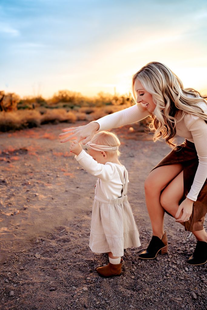 Mom spinning around baby girl in an Arizona state park. 