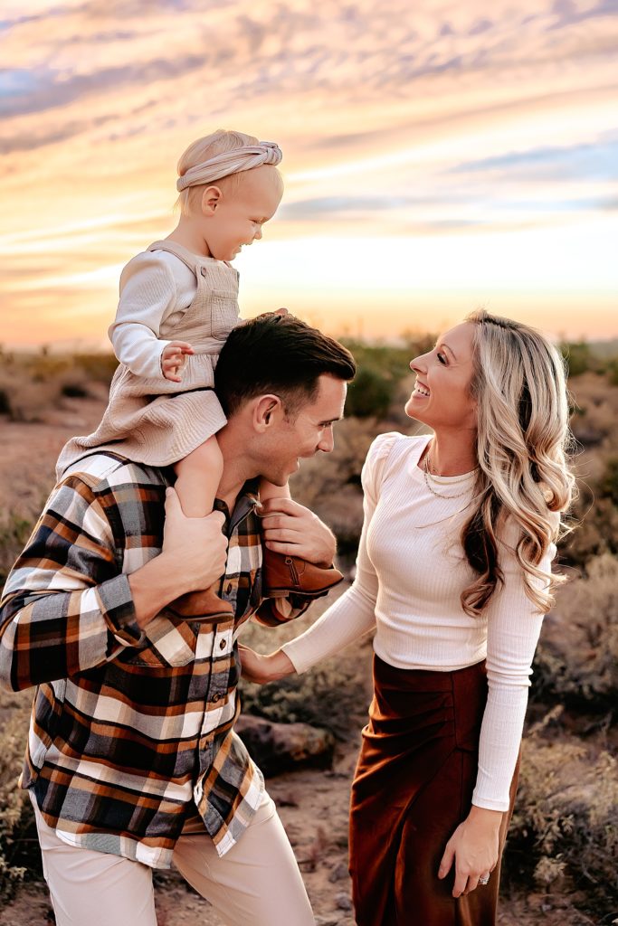 Family of three laughing and playing together for their family session at Lost Dutchman State Park. 